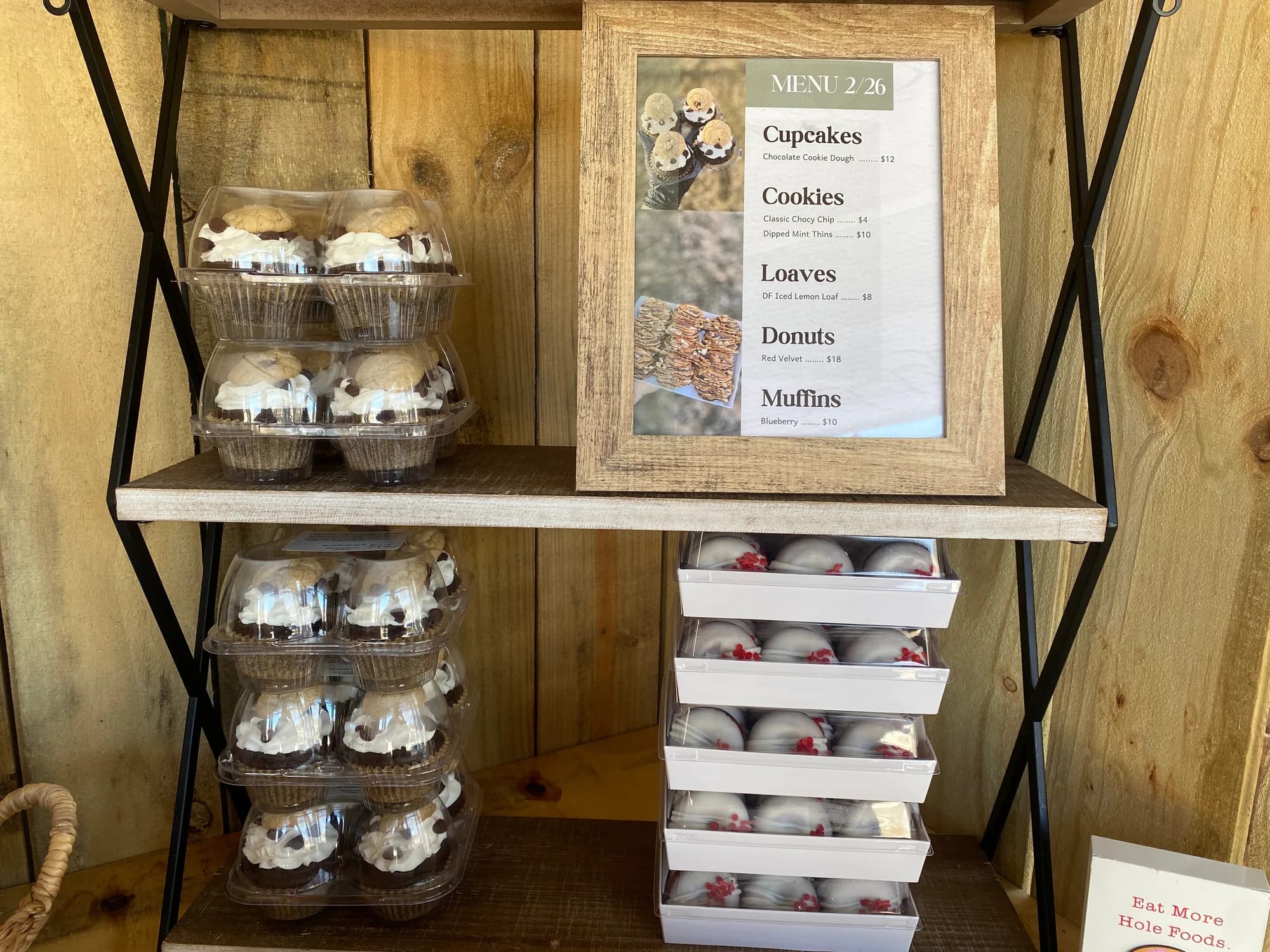 BATG cupcakes and menu sign on the farmstand display shelves